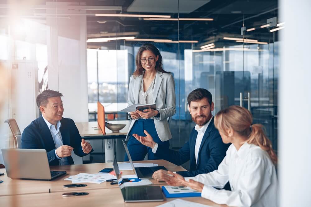 A group of business people using laptops for project discussion